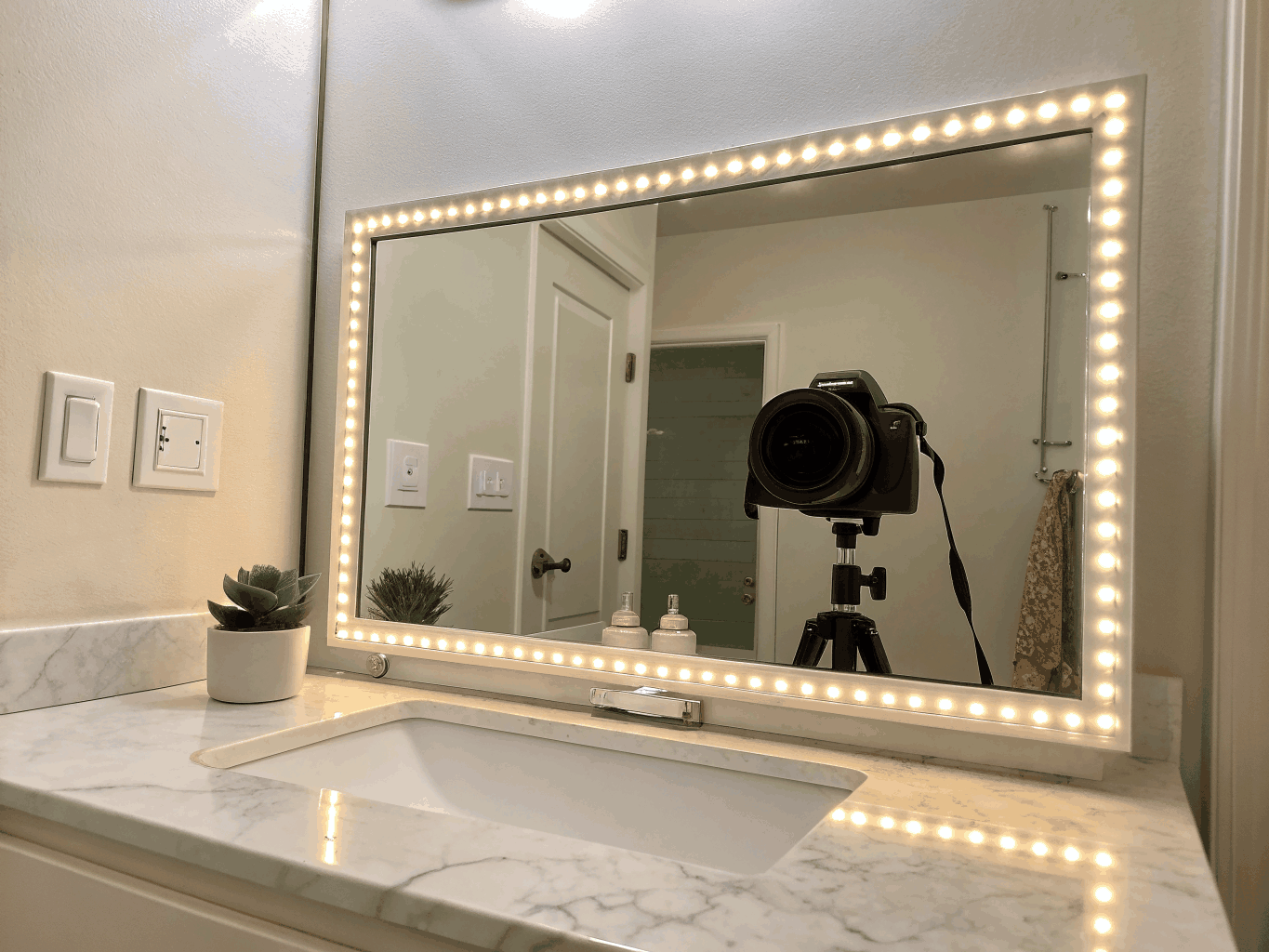 Bathroom vanity with custom mirror and lighting